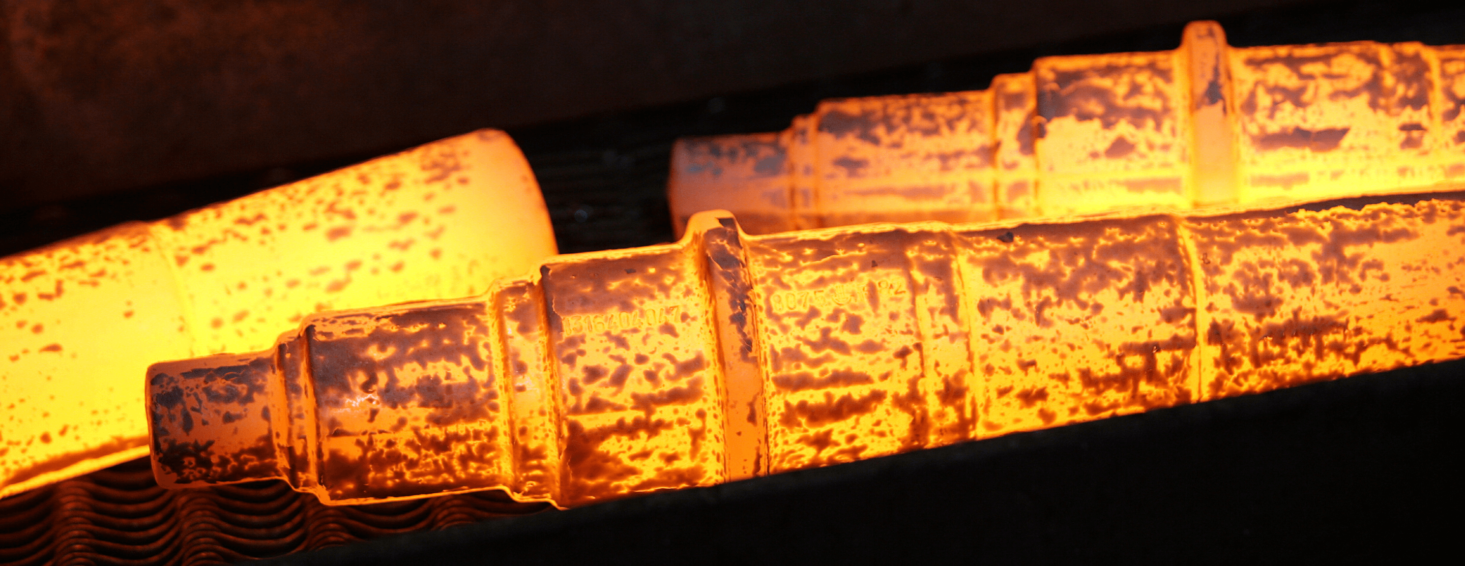 glowing red-hot steel going through the drop forging process
