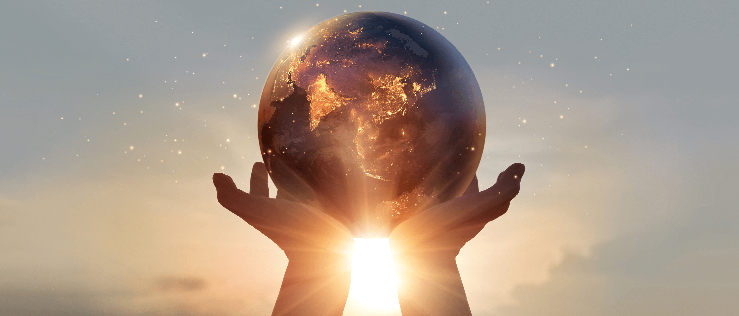 a pair of hands holding the world globe