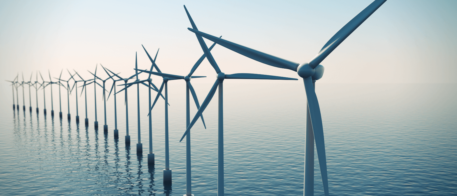 A row of windmills in a body of water